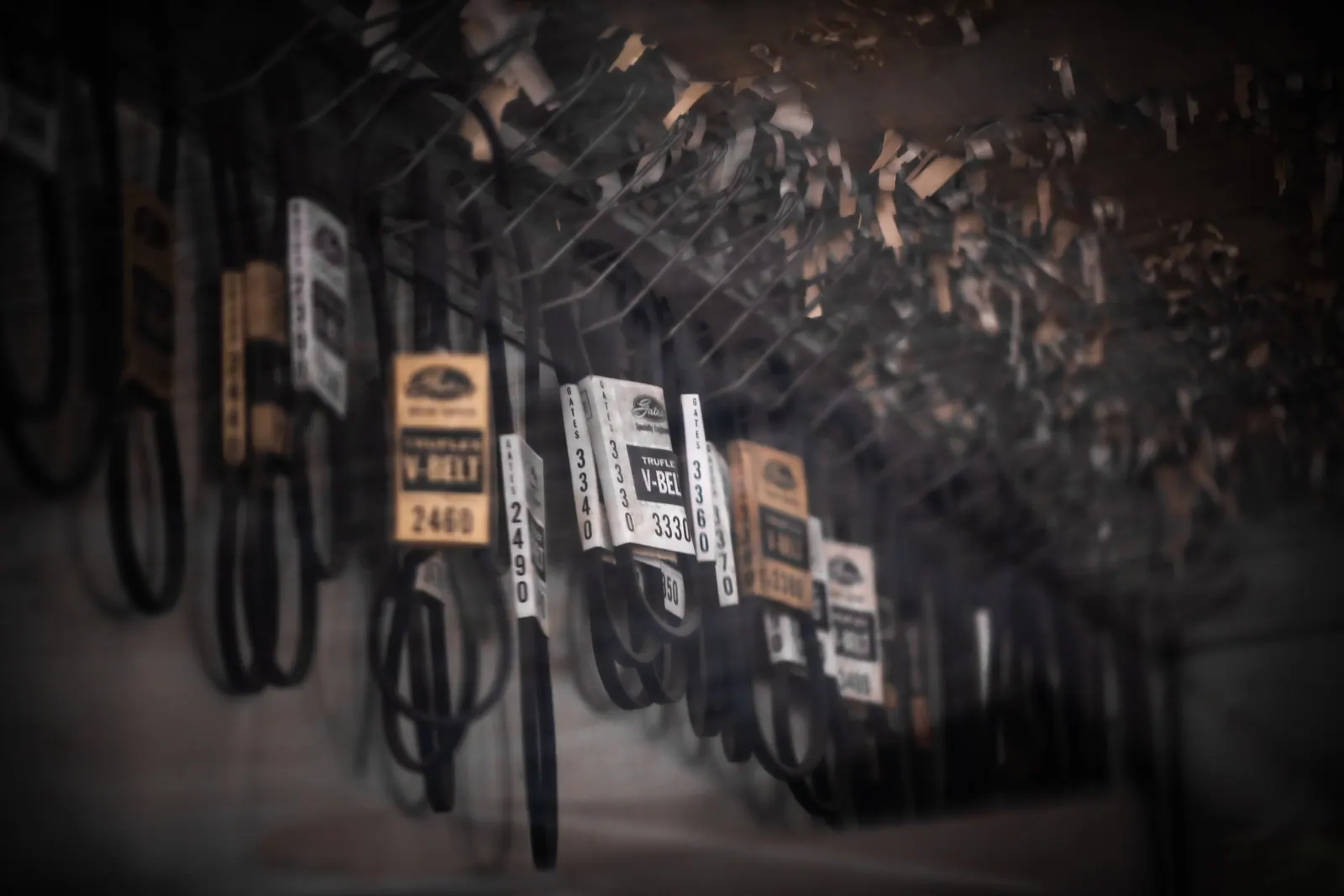 Rows of numbered keys hang on hooks in warm, shallow light.