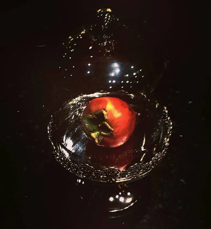 A small red object is surrounded by rippling water and bright bubbles.