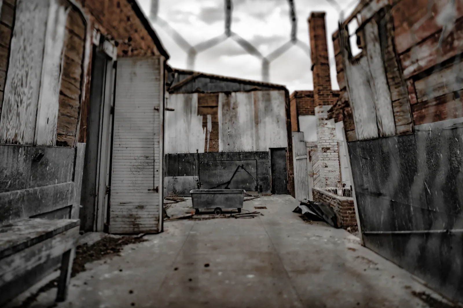 Peeling walls and exposed brick enclose an empty, roofless courtyard.