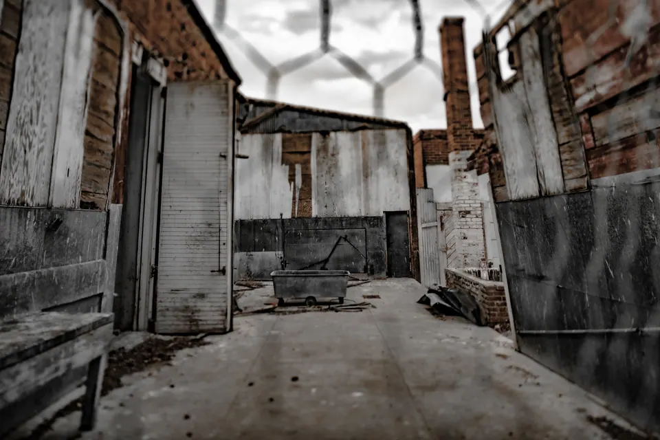 Peeling walls and exposed brick enclose an empty, roofless courtyard.
