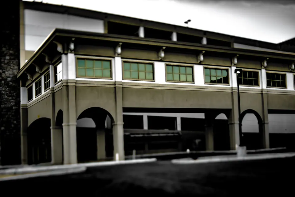 Green windows run along the upper floor of a broad historic building.