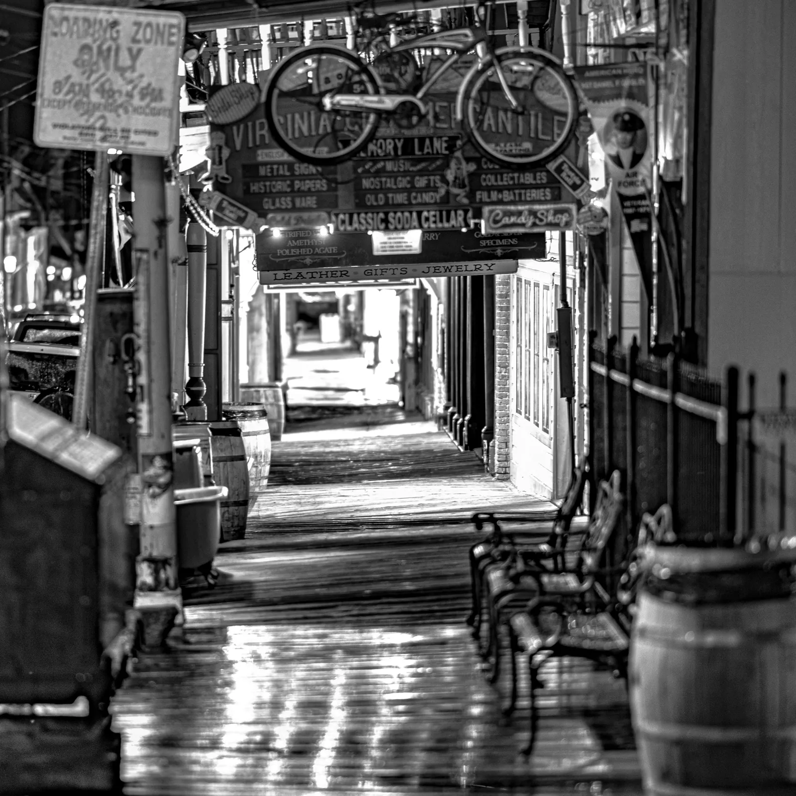 A covered walkway with hanging signs recedes between old storefronts.