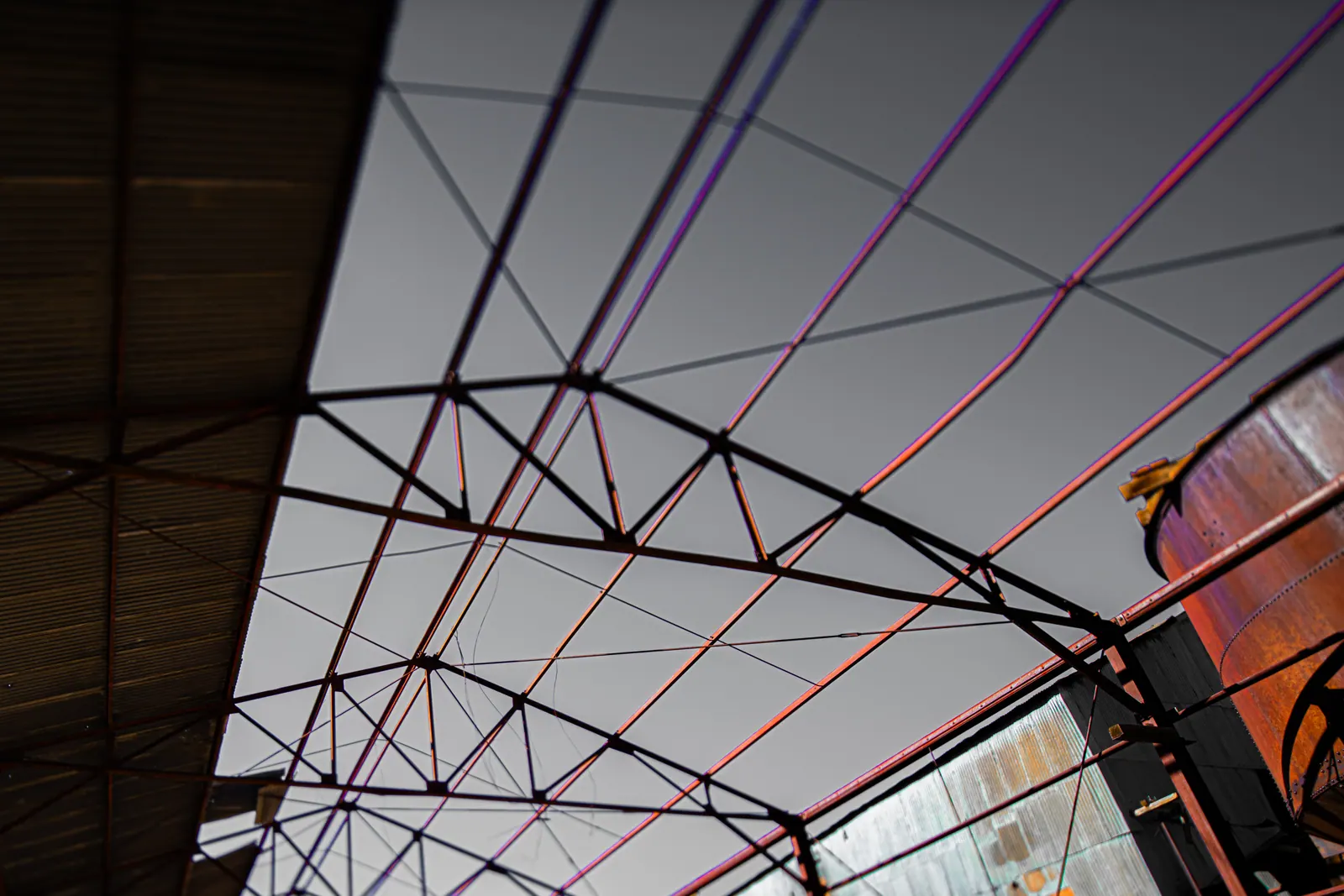 Coloured wires stretch across the sky above a weathered building.